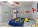 bedroom featuring gray walls, dinosaur accents, and a bed with playful dinosaur-themed bedding at 2709 Banks Lake Ct, Fuquay Varina, NC 27526
