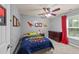 bedroom with gray walls, ceiling fan, dinosaur decor, and a cozy dinosaur-themed bed at 2709 Banks Lake Ct, Fuquay Varina, NC 27526