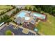 Aerial view of the community pool and playground with lots of seating and a clubhouse in a well-maintained neighborhood at 2709 Banks Lake Ct, Fuquay Varina, NC 27526