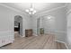 Spacious dining room features hardwood floors and crown molding with arched doorways and views to the kitchen at 2709 Banks Lake Ct, Fuquay Varina, NC 27526