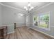 The dining room features hardwood floors and crown molding with views of the front yard and front door at 2709 Banks Lake Ct, Fuquay Varina, NC 27526