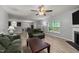 Spacious living room features wood floors, fireplace, ceiling fan, and natural light from a large window at 2709 Banks Lake Ct, Fuquay Varina, NC 27526