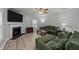 Bright living room with fireplace, large windows with backyard views, ceiling fan and hardwood floors at 2709 Banks Lake Ct, Fuquay Varina, NC 27526