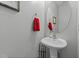 The powder room features a pedestal sink, an oval mirror, and a towel ring at 2709 Banks Lake Ct, Fuquay Varina, NC 27526