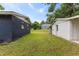 Large backyard with the main house on the left and garage on the right, surrounded by lush greenery at 2752 Weldon Ter, Durham, NC 27703