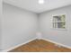 Cozy bedroom with warm hardwood floors, a neutral paint color, and a bright window with blinds at 2752 Weldon Ter, Durham, NC 27703