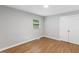 Relaxing bedroom featuring hardwood floors, a window, and a closet with double doors at 2752 Weldon Ter, Durham, NC 27703
