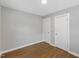 Modern bedroom features neutral paint, hardwood floors, and a white door to the closet at 2752 Weldon Ter, Durham, NC 27703