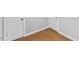 Classic bedroom features pristine baseboards, warm hardwood floors, and white doors with dark hardware at 2752 Weldon Ter, Durham, NC 27703