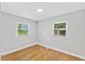 Inviting bedroom featuring hardwood floors, neutral paint, and a window with natural light at 2752 Weldon Ter, Durham, NC 27703