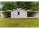 Spacious detached garage with a car port and neutral colors on a lush lawn at 2752 Weldon Ter, Durham, NC 27703