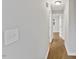 Hallway with hardwood floors, light gray walls and white trim at 2752 Weldon Ter, Durham, NC 27703