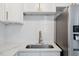 Close-up of a modern kitchen featuring sleek countertops, stainless steel appliances, and a stylish sink at 2752 Weldon Ter, Durham, NC 27703