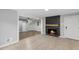 Bright living room with fireplace, hardwood floors, and an open doorway to another room at 2752 Weldon Ter, Durham, NC 27703