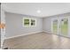 Bright living room featuring light gray walls, wood-look flooring, and french doors at 2752 Weldon Ter, Durham, NC 27703