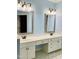 Bathroom with a double sink vanity, framed mirrors, decorative lighting, and blue walls at 306 Fincastle Dr, Cary, NC 27513