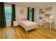 Cozy bedroom with a bed, side table, desk, bookshelf, and hardwood floors at 306 Fincastle Dr, Cary, NC 27513