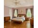 Nicely furnished bedroom with wood furniture and a bed, and two windows providing natural light at 306 Fincastle Dr, Cary, NC 27513