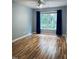 Bedroom with hardwood floors and a window providing natural light at 306 Fincastle Dr, Cary, NC 27513