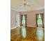 Spacious bedroom with beautiful hardwood floors, neutral curtains, white trim, and a ceiling fan at 306 Fincastle Dr, Cary, NC 27513