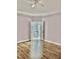 A bedroom with hardwood floors and white trim leads through a doorway into the ensuite bath at 306 Fincastle Dr, Cary, NC 27513