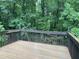 Relaxing deck showcasing backyard with tall trees at 306 Fincastle Dr, Cary, NC 27513
