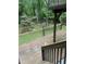 Wooden deck stairs overlook a lush green backyard with mature trees and serene landscaping at 306 Fincastle Dr, Cary, NC 27513