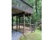 View of the wooden deck with wooden railings and posts overlooking the wooded yard at 306 Fincastle Dr, Cary, NC 27513