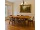 Formal dining room features an eight-seat table, stylish wood floors, and a bay window at 306 Fincastle Dr, Cary, NC 27513