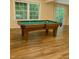 Spacious game room featuring a billiards table and a large sliding glass door to the outdoors at 306 Fincastle Dr, Cary, NC 27513