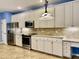 A well-lit kitchen featuring stainless steel appliances, ample cabinet space, and granite countertops at 306 Fincastle Dr, Cary, NC 27513