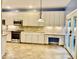 Updated kitchen boasts granite countertops, stainless steel appliances, and tiled floors at 306 Fincastle Dr, Cary, NC 27513