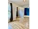 An empty living room features luxury vinyl plank floors and a large window that lets in ample natural light at 306 Fincastle Dr, Cary, NC 27513