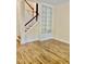 Sunlit living room featuring wood floors and built-in bookshelves next to the staircase at 306 Fincastle Dr, Cary, NC 27513