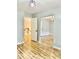 A large room with luxury vinyl plank floors and a doorway leading to a staircase in the home at 306 Fincastle Dr, Cary, NC 27513