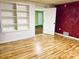 Spacious room featuring hardwood floors, built-in shelving and a doorway to an adjacent room at 306 Fincastle Dr, Cary, NC 27513