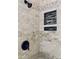 Nicely tiled shower with a rainfall shower head, shelving, and bronze fixtures at 306 Fincastle Dr, Cary, NC 27513