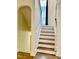 Classic staircase with hardwood steps, white risers, and decorative molding with natural light at 306 Fincastle Dr, Cary, NC 27513