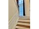 Elegant staircase with hardwood steps, white risers, and detailed trim illuminated by a window at 306 Fincastle Dr, Cary, NC 27513
