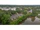 Apartment building with balconies and parking near a lake, surrounded by greenery and commercial areas at 3077 Huntleigh Dr, Raleigh, NC 27604