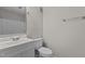 Clean bathroom features a white vanity, toilet, and mirror, offering a functional and bright space at 3077 Huntleigh Dr, Raleigh, NC 27604