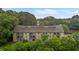 Stunning aerial view of a large, multi-story condo building featuring multiple balconies and nestled amongst lush greenery at 3077 Huntleigh Dr, Raleigh, NC 27604