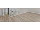 Hallway with wood-look floors and white railings at 3077 Huntleigh Dr, Raleigh, NC 27604