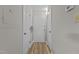 Bright hallway with hardwood flooring and a white front door at 3077 Huntleigh Dr, Raleigh, NC 27604