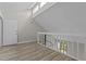Hallway with light wood-look floors and white railings at 3077 Huntleigh Dr, Raleigh, NC 27604