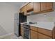 The modern kitchen features sleek appliances and stylish wood cabinetry at 3077 Huntleigh Dr, Raleigh, NC 27604