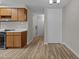 Galley kitchen featuring wood cabinets, white countertops, and a view to the front entrance at 3077 Huntleigh Dr, Raleigh, NC 27604