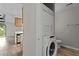 Convenient laundry area with a stacked washer and dryer, located near the kitchen and living spaces at 3077 Huntleigh Dr, Raleigh, NC 27604