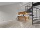 Interior showcasing the spiral staircase, updated flooring and kitchen layout at 3077 Huntleigh Dr, Raleigh, NC 27604