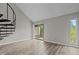 Spacious living room with new floors, spiral staircase, and sliding glass door to balcony at 3077 Huntleigh Dr, Raleigh, NC 27604